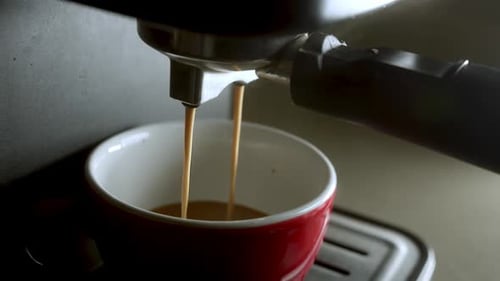 Pouring Coffee Stream From Machine in Cup Home Making Hot Espresso Using Filter Holder Flowing Fresh