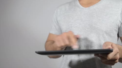 Close Up of Man using Digital Tablet