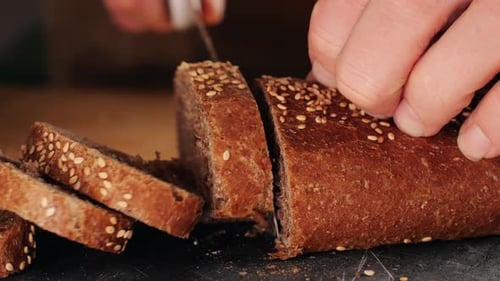 Loaf Of Bread Sliced With Knife In Kitchen