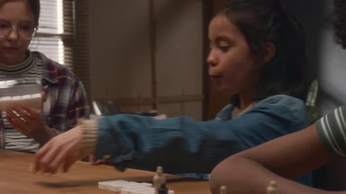 Happy Chewing Girls Playing Domino