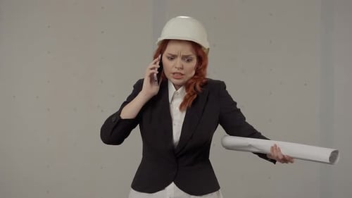Architect talking on phone in construction area
