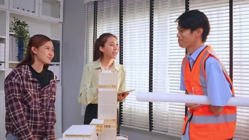 Asian young businessman amputee without arm work with team in office.