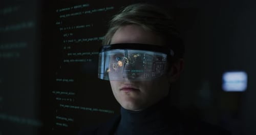 An young man is using futuristic innovative technology vr mask with augmented reality holograms on