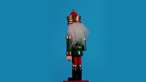 Festive Nutcracker Toy Soldier Rotating on Blue Background