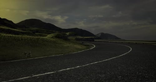 Curving Road Through Serene Landscape Under Moody Evening Sky
