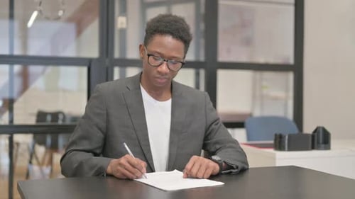African American Man Working on Documents in Office