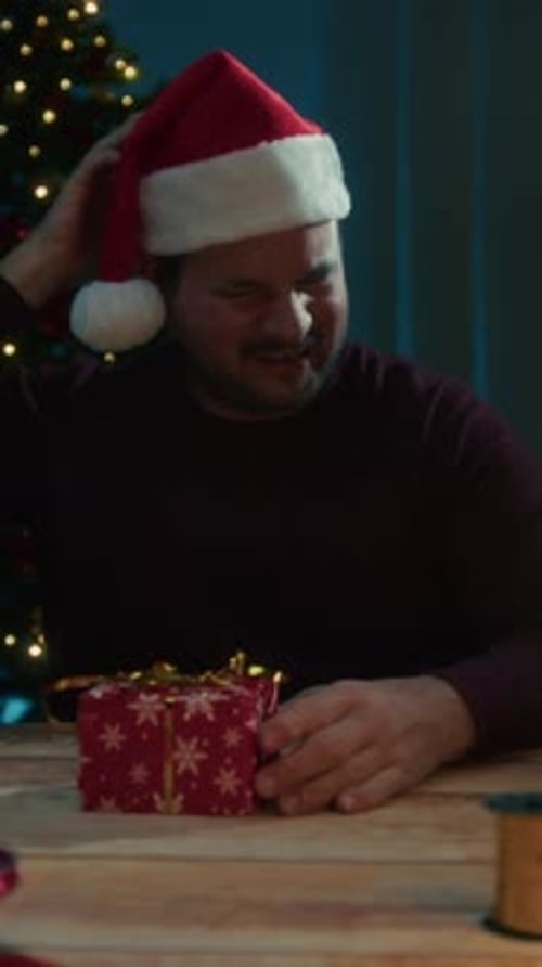 Young Man Falls Asleep At Night Making Christmas Gifts On Desk