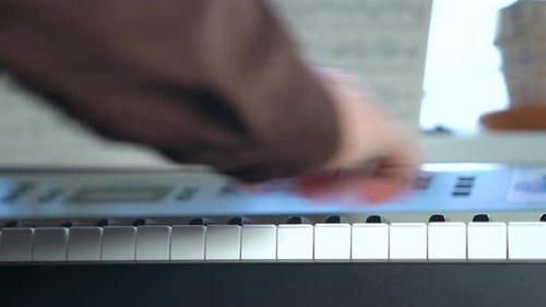 Person Playing Piano Close Up at Home