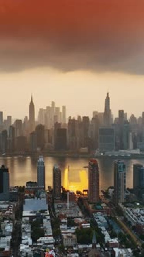 Overcast skies above Manhattan. New York downtown cityscape at orange sunset. Top view.