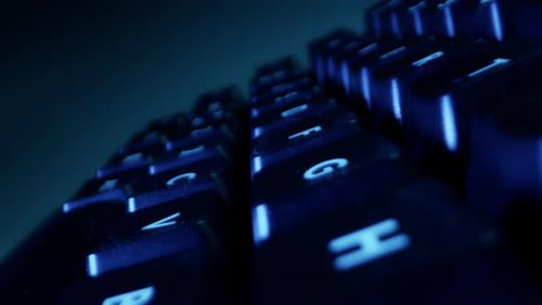 Close-up of Buttons of Black Keyboard in Colorful Backlight