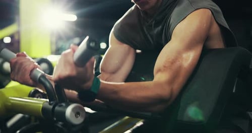 Fitness, bodybuilding and man with machine, gym and exercise for wellness and muscle with equipment