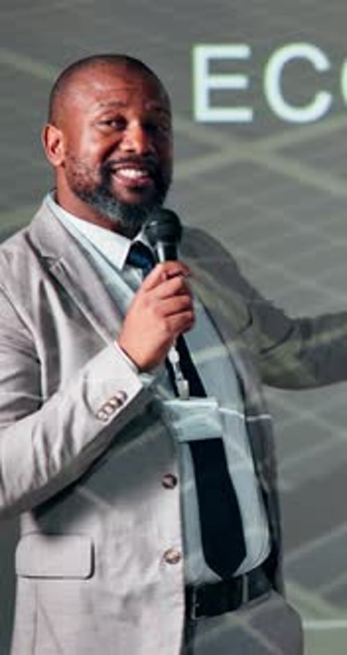 Summit, speaker and businessman with microphone on stage for economy growth