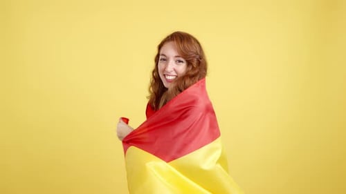 Woman Smiles with Red and Yellow Flag