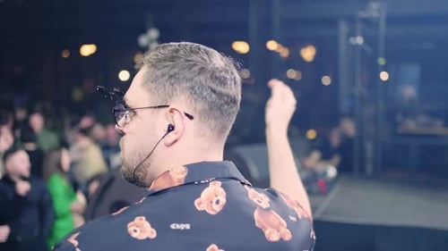 Nightclub DJ Performs for Dancing Crowd