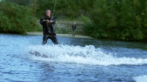 Man Wakeboarding and Doing Tricks on Lake Water