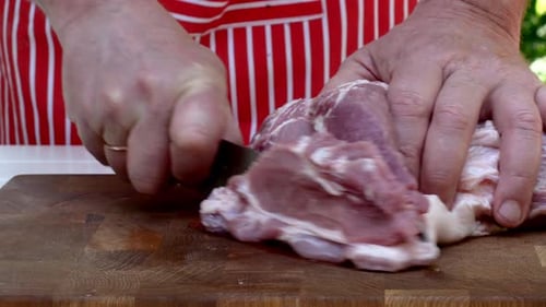 Expertly Slicing Juicy Pork Into Big Mouthwatering Chunks to Grilling on BBQ