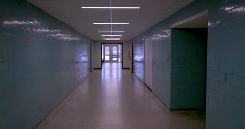 Empty school hallway with gimbal video walking forward.