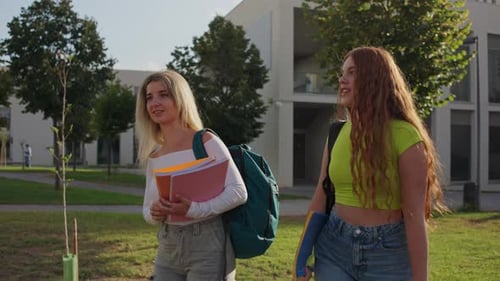 Two University Students Walking and Talking on Campus