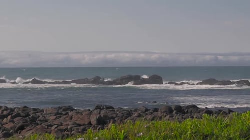 Waves Crashing on Rocky Beach on Sunny Day