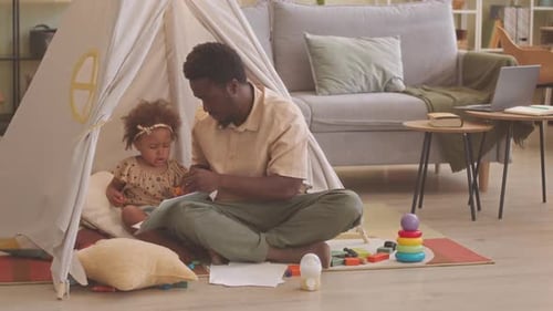 Dad and Little Girl Reading in Play Tent
