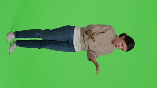 Vertical Video Side View of Displeased Adult Acting Furious on Full Body Greenscreen