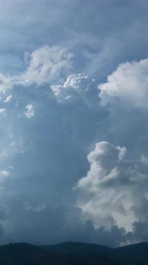 Beautiful summer day sky with fluffy white clouds time lapse in bright blue atmosphere