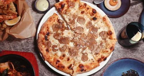 Overhead view of pizza and seafood delicacies