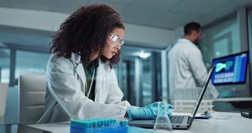 Scientist Working in Modern Laboratory with Laptop