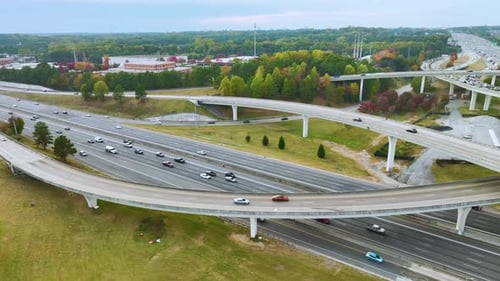 Luftbild der amerikanischen Autobahnkreuzung mit schnell fahrenden Autos und Lastwagen