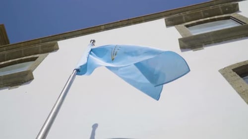 Blue Flag Waving in the Wind on Sunny Day