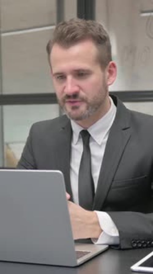 Businessman Talking During Online Meeting on Laptop