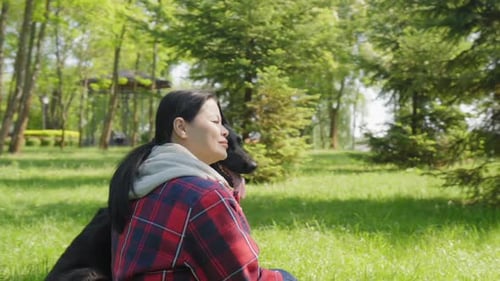 Rear View of Woman Pet Owner with Dog Enjoying Leisure and Summer Nature