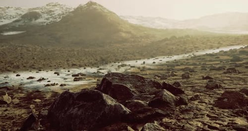 Stunning Rocky Landscape with Snow Capped Mountains at Dusk