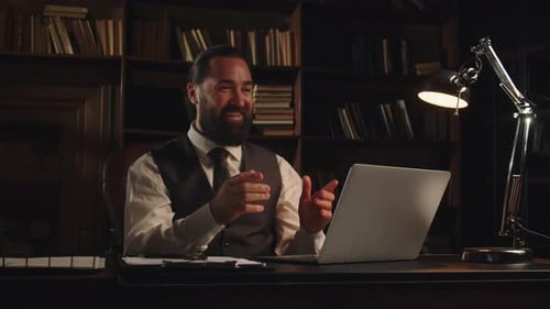 Man Video Conferencing in Home Office at Night