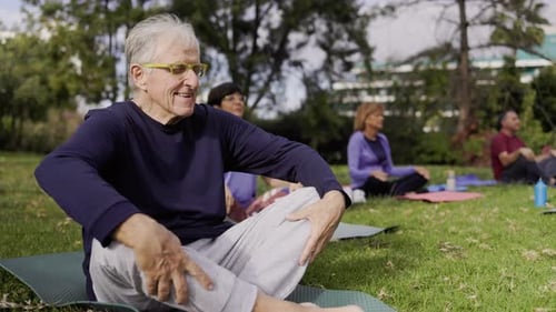 Sport senior people doing yoga meditation workout outdoors at park city - Elderly health care