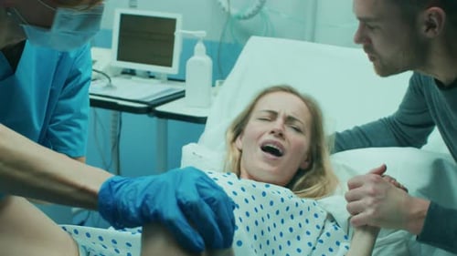 Primer plano del rostro de una mujer en trabajo de parto que se esfuerza por dar a luz, con la ayuda de obstetras, su cónyuge
