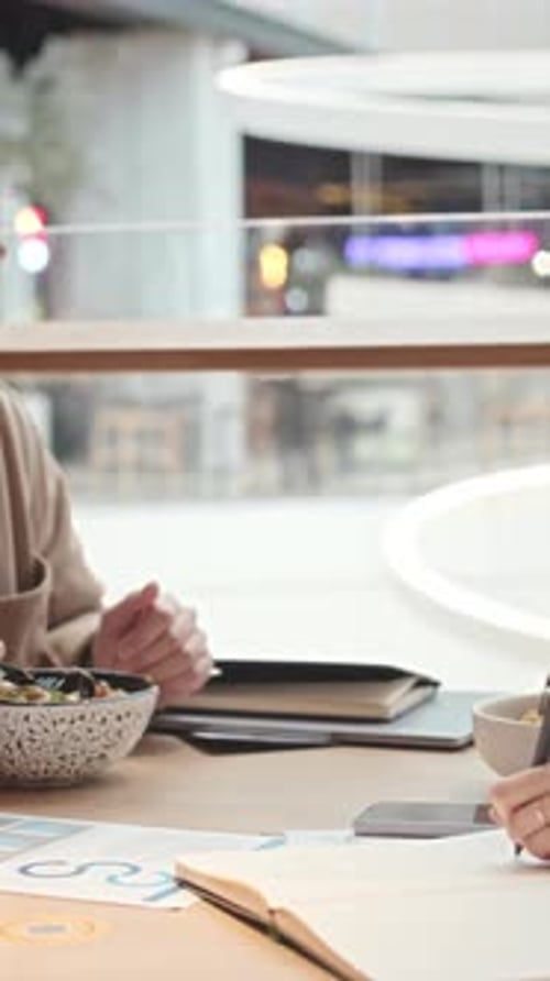 Colleagues Discussing Work at Lunch Break in Restaurant