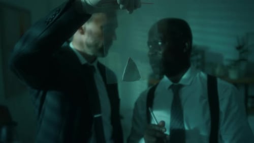 Detectives Examine Evidence in Dark Crime Scene