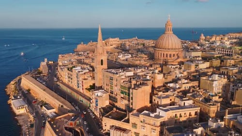 Aerial Dusk Sweep of Valletta Malta with Basilica Dome and Spire