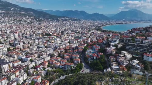 Aerial Video of a Mediterranean City Surrounded By Green Hills a Bright Blue Ocean and a Picturesque
