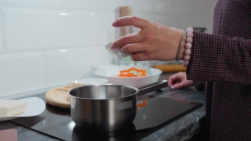 Person Cooking in Kitchen