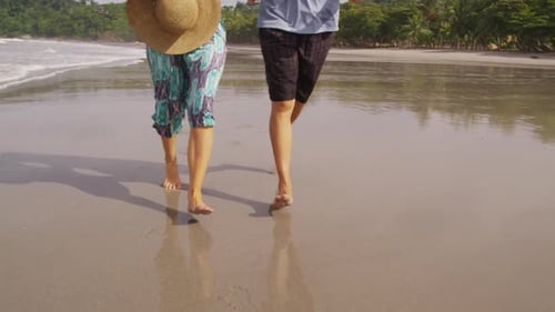 Couple Running on Sunny Tropical Beach