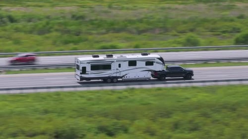 Truck Towing RV Camper Trailer Driving at High Speed on American Freeway in Florida USA Travel