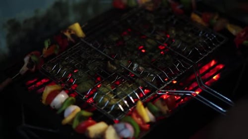Grilling Vegetables on a Shish Kabob at Night