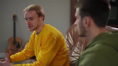 Men Having a Conversation Sitting Indoors