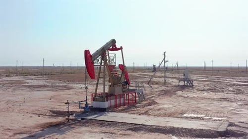 Oil Pump Jack Symbol of Energy Resources in Desert Field