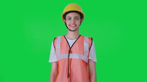 Happy Indian female construction worker Green screen