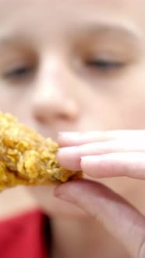 Fair Haired Child Enjoying Fried Chicken