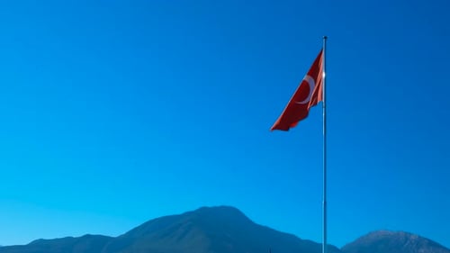 Bright Flag Waving Against a Clear Blue Sky