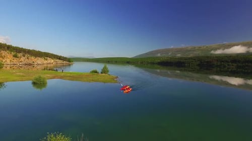 People kayaking in river, green nature and blue sky.